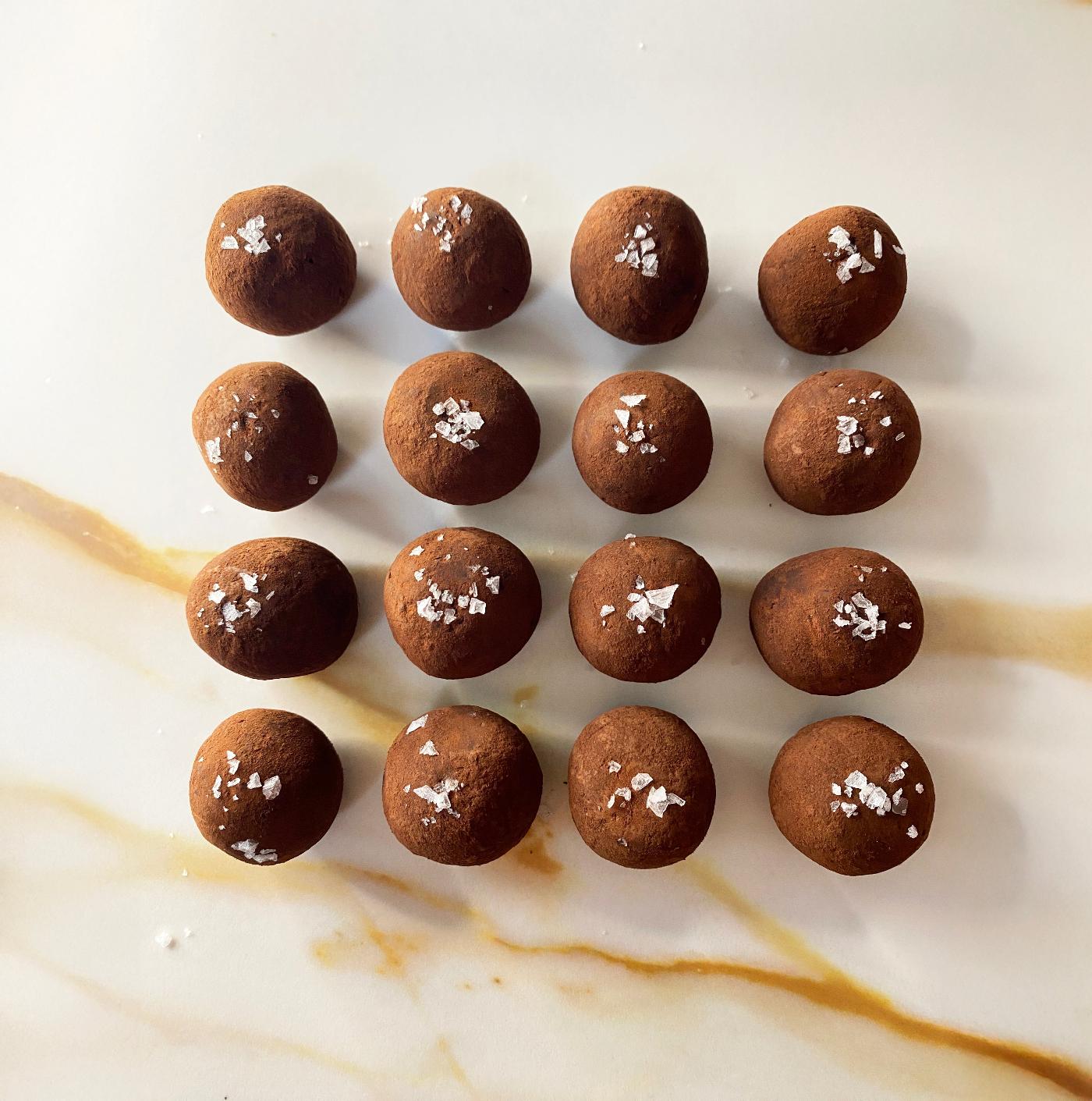 Chocolate date truffles with sea salt on a marble surface